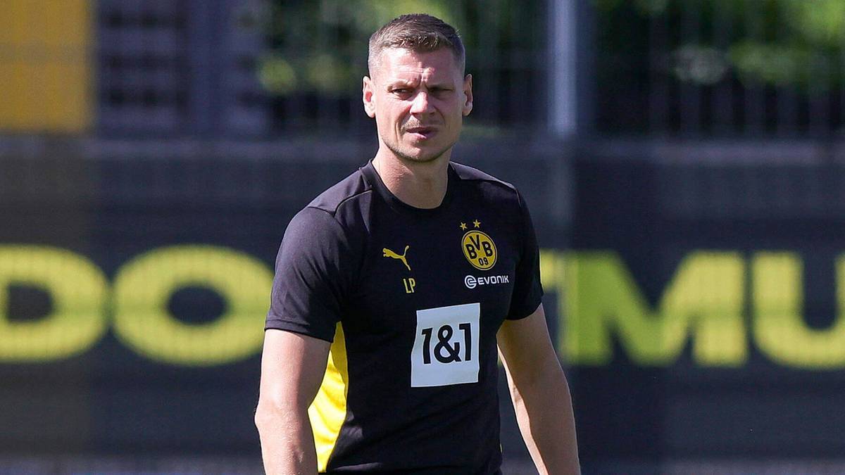 Łukasz Piszczek, nowy szkoleniowiec LKS Goczałkowice-Zdrój, ubrany w czarną koszulkę z logo.