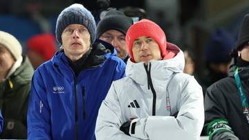 Dw&oacute;ch mężczyzn w zimowych kurtkach i czapkach, stojących blisko siebie, z widocznymi fragmentami twarzy.