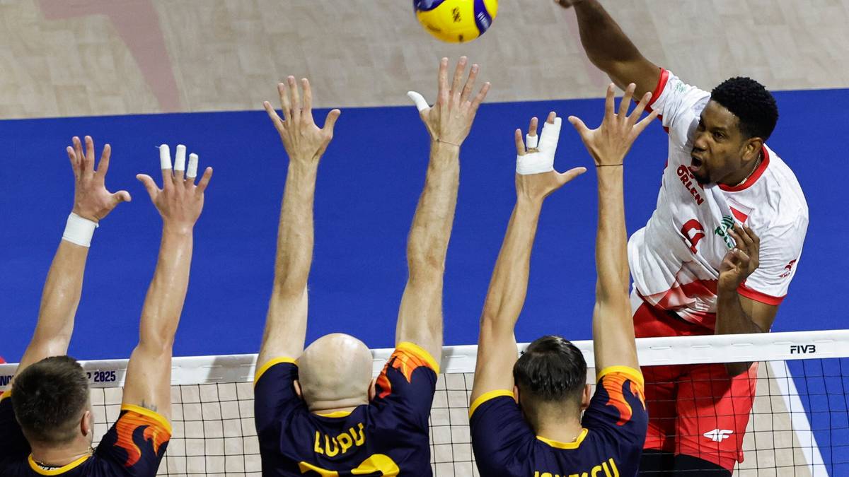 Siatkarze podczas rozgrywki, jeden z nich wykonuje atak piłką do siatkówki.