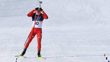 Biathlonista Dale-Skjevdal z karabinem na plecach, świętujący zwycięstwo na śnieżnym stoku.