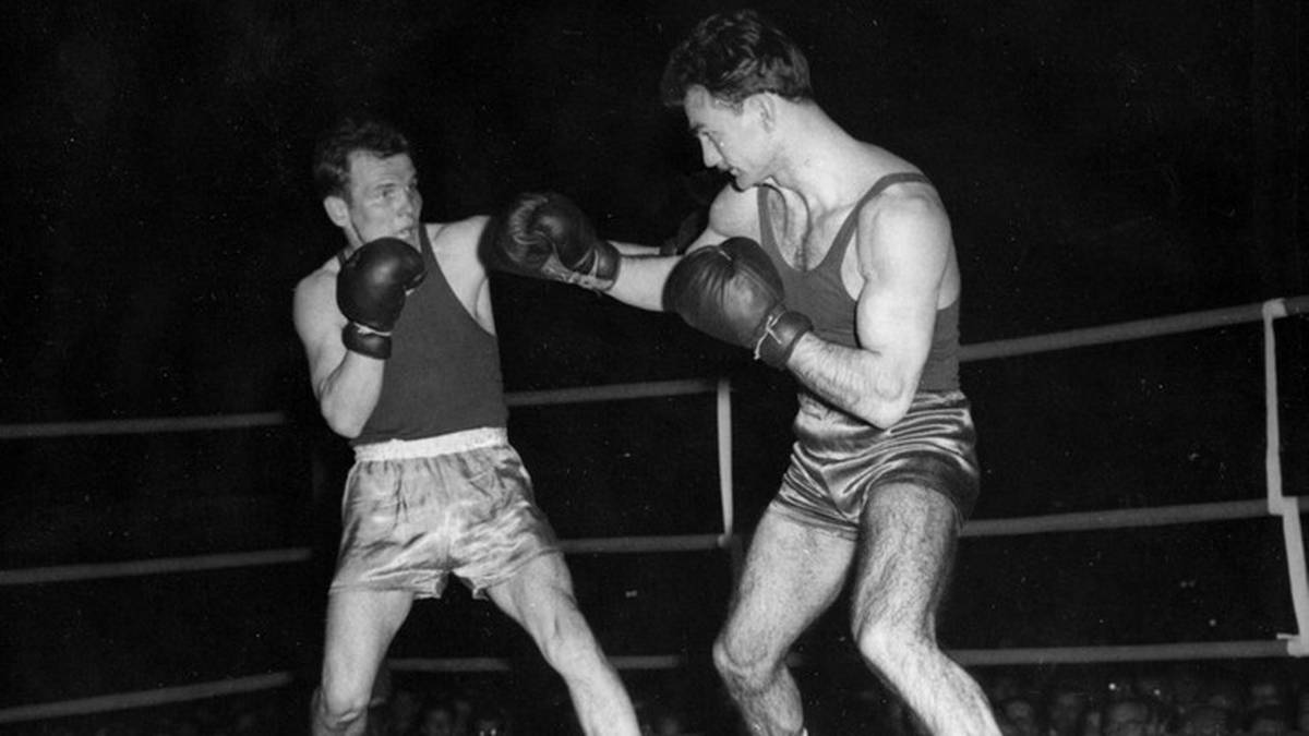 Dw&oacute;ch bokser&oacute;w w rękawicach walczy w ringu.