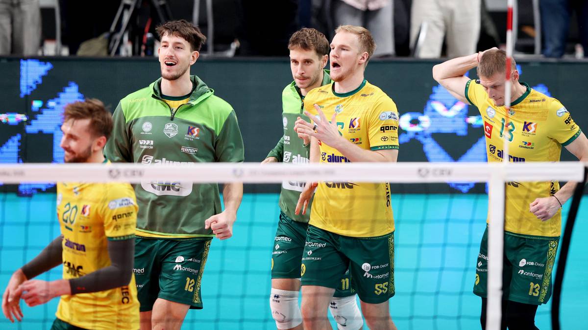 Grupa siatkarzy w ż&oacute;łto-zielonych strojach sportowych podczas meczu.