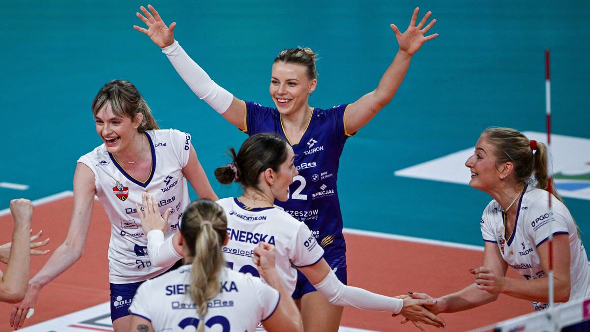 Pięć siatkarek w niebiesko-białych strojach cieszy się ze zwycięstwa na boisku siatkarskim.