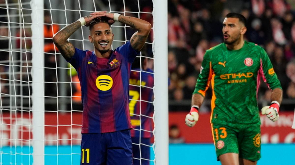 Piłkarz FC Barcelony z rękami na głowie i bramkarz Girony stoją na boisku.