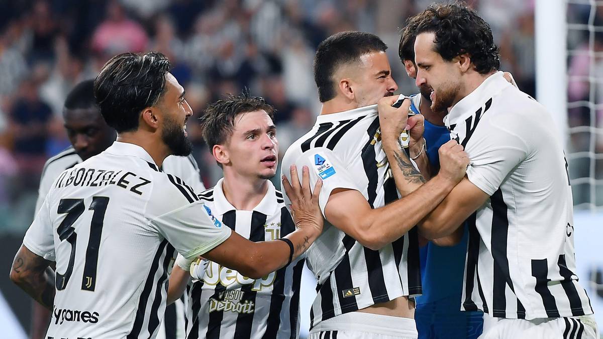 Czterech piłkarzy w biało-czarnych strojach Juventus, z kt&oacute;rych dwaj są w trakcie werbalnej potyczki, podczas gdy dwaj inni pr&oacute;bują ich uspokoić.