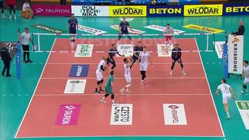 Patrik Indra z drużyny ZAKSA Kędzierzyn-Koźle w akcji podczas meczu siatkówki. Zawodnik w białej koszulce odbija piłkę nad siatką.