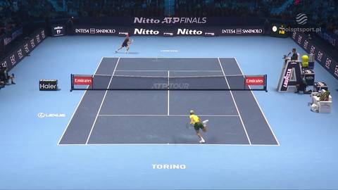 Dwóch tenisistów grających mecz na korcie tenisowym podczas turnieju ATP Finals. Jeden z zawodników jest bliżej widza, drugi jest dalej.