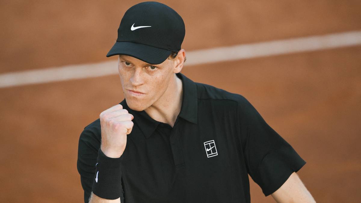 Jannik Sinner z zaciśniętą pięścią, świętujący zwycięstwo.