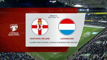 Herb Irlandii Północnej obok herbu Luksemburga, z informacją "EUROPEAN QUALIFIERS", "GROUP A MATCHDAY 10", "NORTHERN IRELAND", "LUXEMBOURG" oraz "THE OVAL TWIST NATIONAL STADIUM AT WINDSOR PARK, BELFAST".