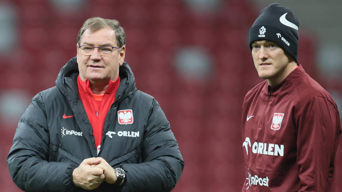 Dwóch mężczyzn w strojach reprezentacji Polski na boisku piłkarskim.