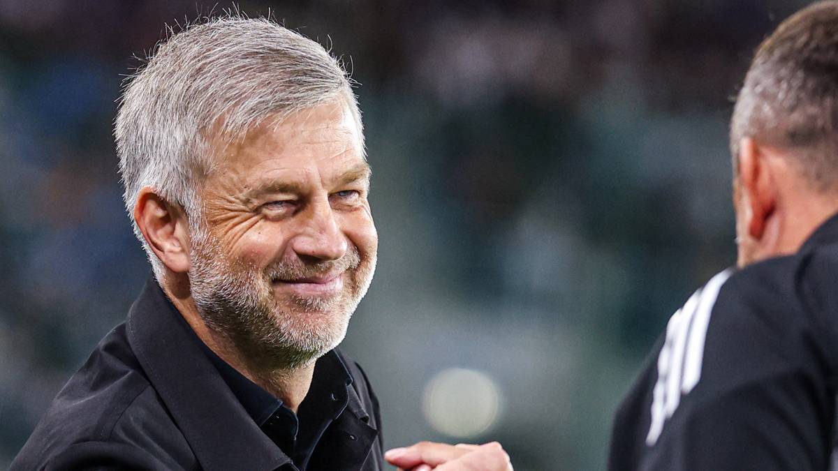 Portret Edwarda Iordanescu, trenera piłkarskiego, z lekko zmrużonymi oczami i uśmiechem.