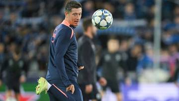 Robert Lewandowski podczas meczu piłki nożnej, kontrolujący piłkę nad głową.