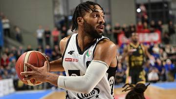 Koszykarz Legii Warszawa z piłką w ręku podczas meczu.