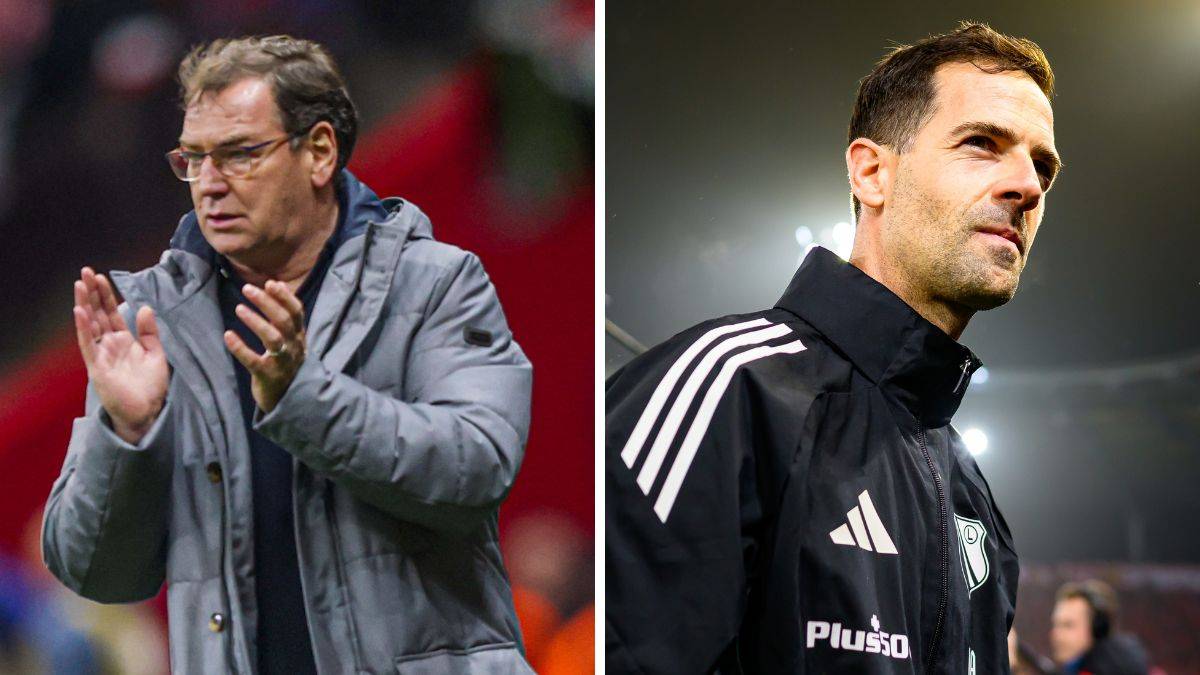 Dwóch trenerów piłkarskich, jeden starszy w szarej kurtce, drugi młodszy w czarnej kurtce sportowej.