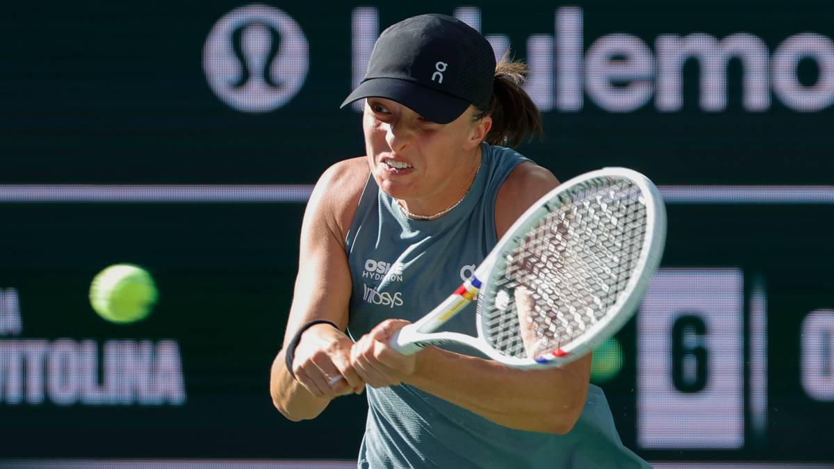 Kobieta w czapce z daszkiem i sportowym topie uderza piłkę tenisową rakietą podczas meczu.