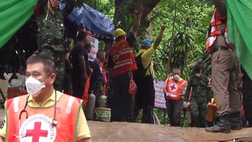 Ratownicy wynoszą dzieci z zalanej jaskini w Tajlandii. Reuters: na powierzchni już ośmiu chłopców