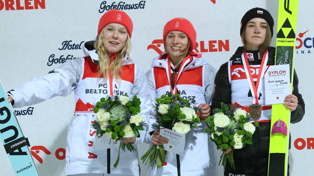 Trzy medalistki Mistrzostw Polski w skokach narciarskich kobiet stoją na podium z kwiatami.